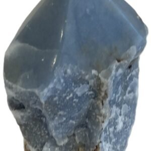 Natural rough angelite freeform crystal with unpolished sides and a smooth polished blue point standing on a white background